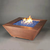 48-inch Copper Canyon gas fire pit by Starfire Designs, emphasizing the blue fire glass and textured hammered copper, ideal for luxury modern fire pits