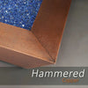 Detail view of the 48-inch Copper Canyon gas fire pit by Starfire Designs, showcasing the hammered copper finish and vibrant blue fire glass, perfect for upscale outdoor fire pits
