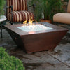 48-inch Copper Canyon gas fire pit by Starfire Designs, placed in an elegant outdoor setting, with a hammered copper finish, enhancing luxurious outdoor living spaces