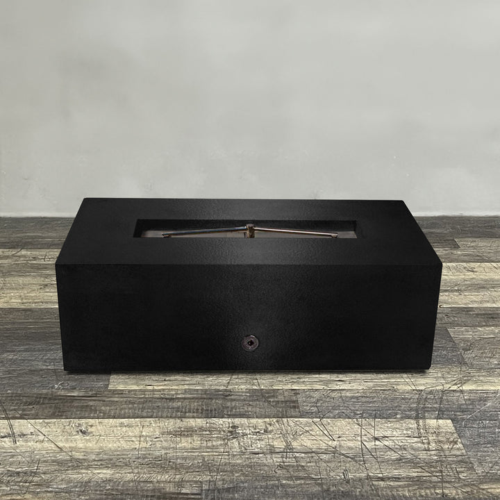 A side view of the 48" x 24" Rectangle Gravity Powder Coated Steel Fire Pit - Natural Gas - 110V Electronic Ignition System - Black Hammertone by Starfire Designs - perfect for outdoor patio spaces. Natural gas or propane compatible, enhancing warmth and ambiance. Lava rocks included for added aesthetic.