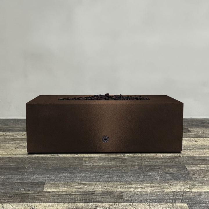 A side view of the 48" x 24" Rectangle Gravity Powder Coated Steel Fire Pit - Propane Gas Hardline - 110V CSA Hi/Lo Electronic Ignition System w/Bluetooth & Handheld Remote - Bronze Hammertone by Starfire Designs - perfect for outdoor patio spaces. Natural gas or propane compatible, enhancing warmth and ambiance. Lava rocks included for added aesthetic.