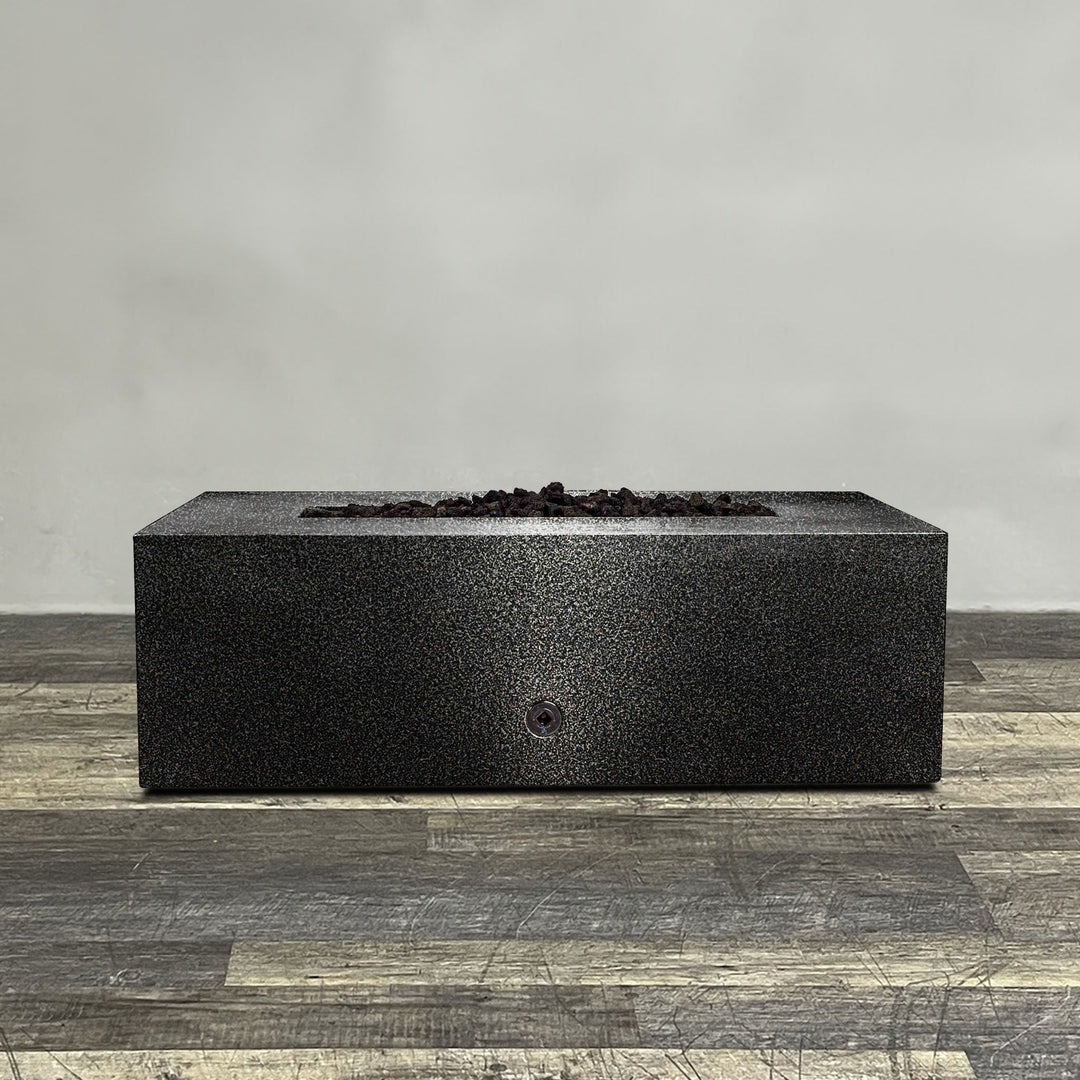 A side view of the 48" x 24" Rectangle Gravity Powder Coated Steel Fire Pit - Propane Gas Hardline - 110V CSA On/Off Electronic Ignition System - Silver Vein by Starfire Designs - perfect for outdoor patio spaces. Natural gas or propane compatible, enhancing warmth and ambiance. Lava rocks included for added aesthetic.