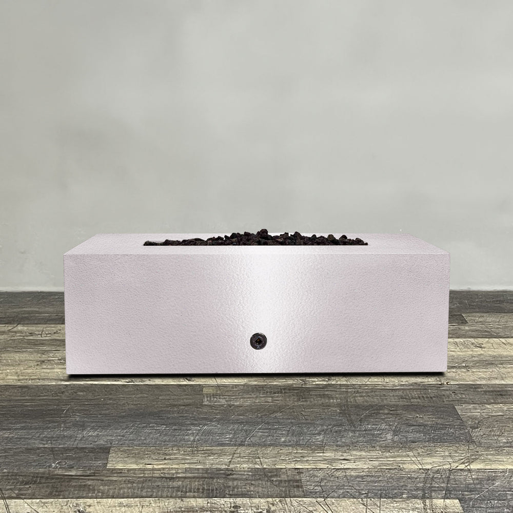 A side view of the 48" x 24" Rectangle Gravity Powder Coated Steel Fire Pit - Propane Gas Hardline - 110V CSA Hi/Lo Electronic Ignition System w/Bluetooth & Handheld Remote - White Hammertone by Starfire Designs - perfect for outdoor patio spaces. Natural gas or propane compatible, enhancing warmth and ambiance. Lava rocks included for added aesthetic.