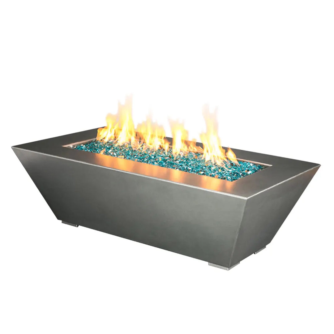 Rectangular fire pit with a contemporary stainless steel design, featuring a 60-inch length, 32-inch width, and 18-inch height, filled with turquoise fire glass and producing a vibrant flame