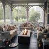 On a screened porch with ornate trim and views of a green yard, a rectangular concrete fire pit glows with a vertical ribbon of flames between white wicker sofas and armchairs covered in floral cushions and striped pillows, the cozy backyard fire pit acting as a low table holding drinks while lanterns, string lights, and a serving tray suggest a relaxed family gathering fire pit scene as the GIF loops through the gentle movement of the flame.