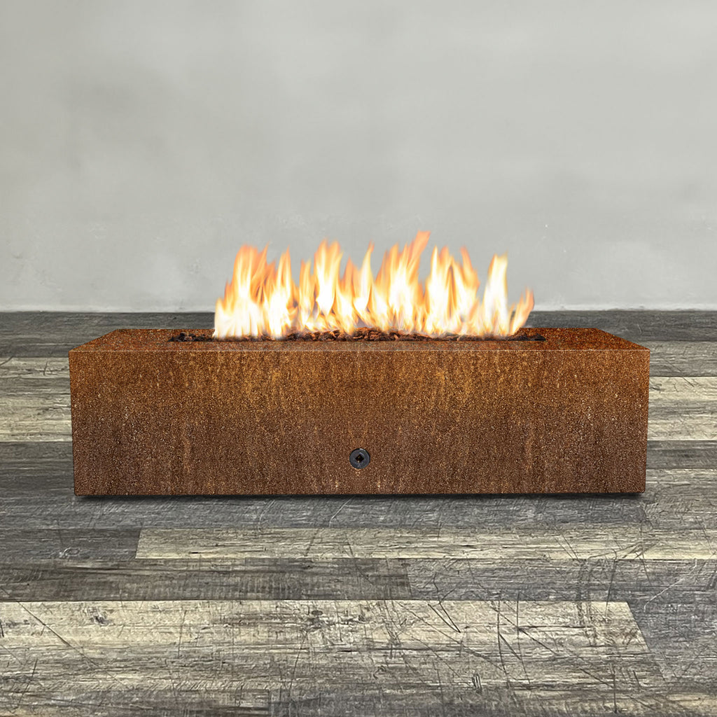 Front view of 60" x 24" Rectangle Gravity Corten Steel Fire Pit by Starfire Designs - Brown with flames on, featuring sleek modern design and durable construction, perfect for outdoor patio spaces. Natural gas or propane compatible, enhancing warmth and ambiance. Lava rocks included for added aesthetic.