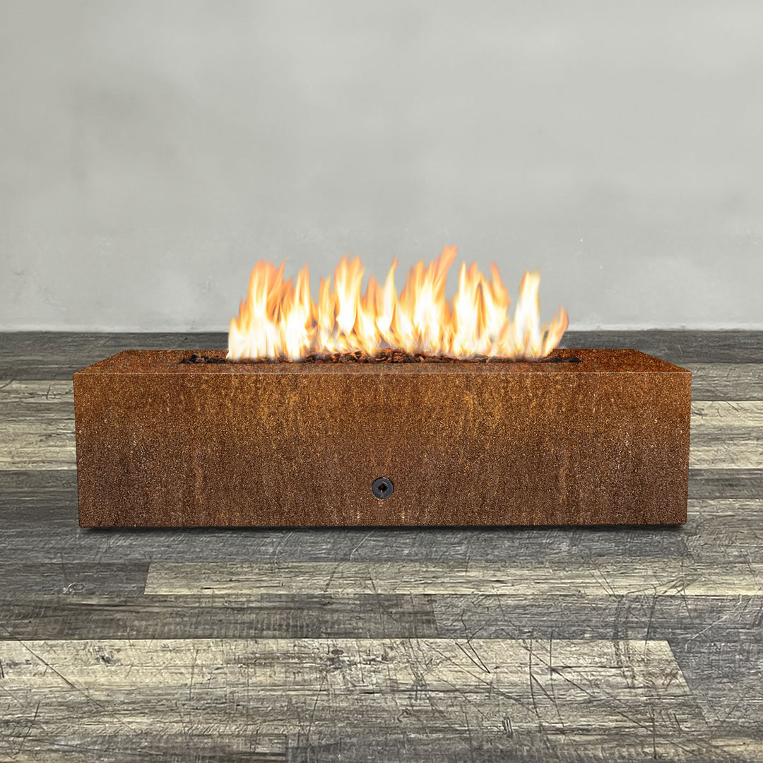 Front view of 60" x 24" Rectangle Gravity Corten Steel Fire Pit by Starfire Designs - Brown with flames on, featuring sleek modern design and durable construction, perfect for outdoor patio spaces. Natural gas or propane compatible, enhancing warmth and ambiance. Lava rocks included for added aesthetic.