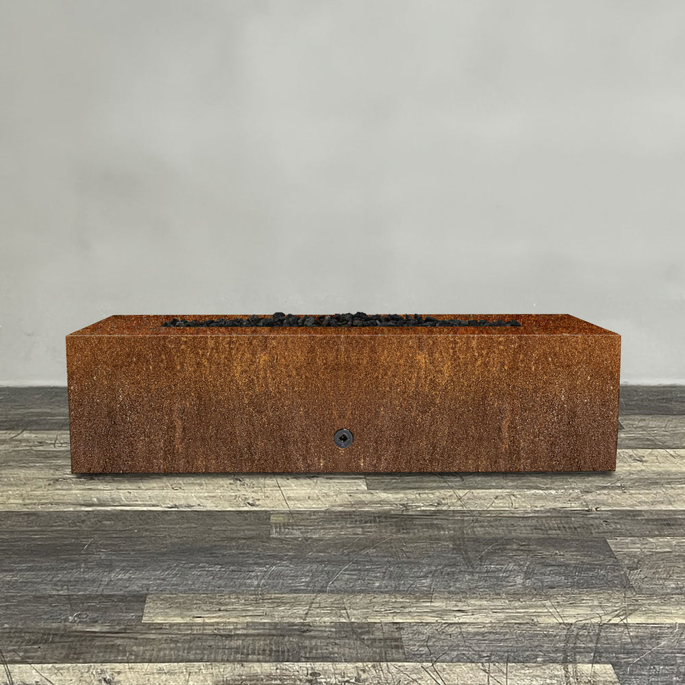 A side view of the 60" x 24" Rectangle Gravity Corten Steel Fire Pit - Propane Gas Hardline - 110V CSA Hi/Lo Electronic Ignition System w/Bluetooth & Handheld Remote by Starfire Designs - perfect for outdoor patio spaces. Natural gas or propane compatible, enhancing warmth and ambiance. Lava rocks included for added aesthetic.