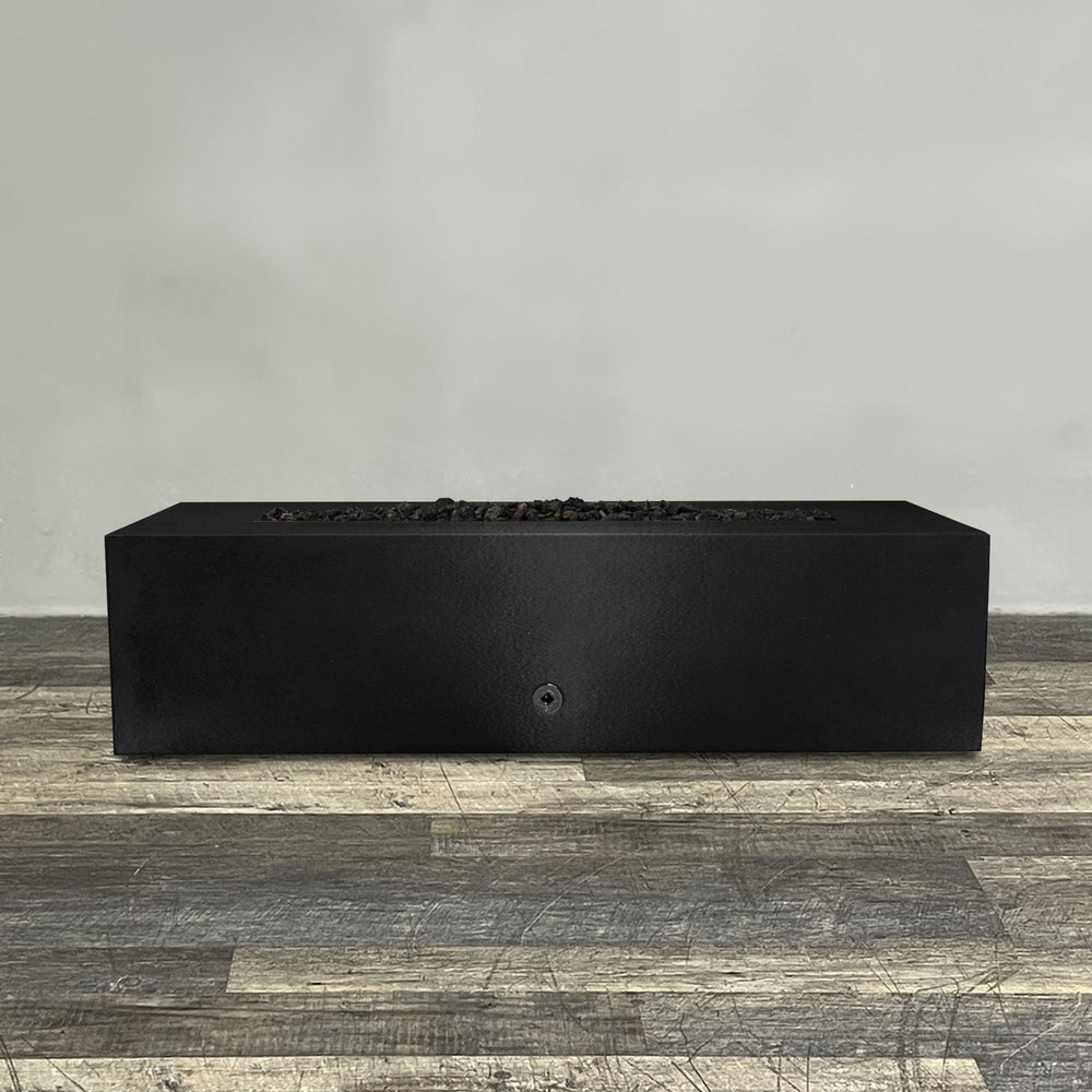 A side view of the 60" x 32" Rectangle Gravity Powder Coated Steel Fire Pit - Propane Gas Hardline - Push Button Spark Ignition - Black Hammertone by Starfire Designs - perfect for outdoor patio spaces. Natural gas or propane compatible, enhancing warmth and ambiance. Lava rocks included for added aesthetic.