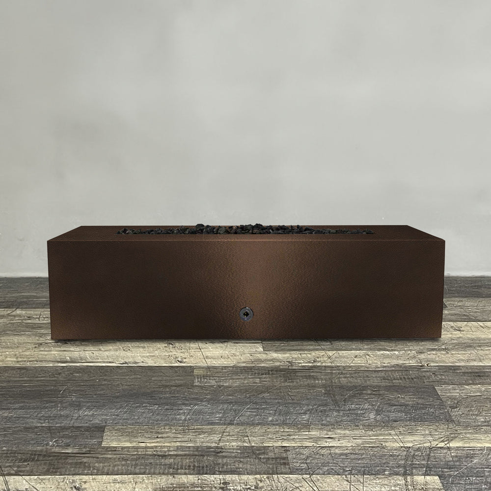 A side view of the 60" x 32" Rectangle Gravity Powder Coated Steel Fire Pit - Propane Gas Hardline - Push Button Spark Ignition - Bronze Hammertone by Starfire Designs - perfect for outdoor patio spaces. Natural gas or propane compatible, enhancing warmth and ambiance. Lava rocks included for added aesthetic.