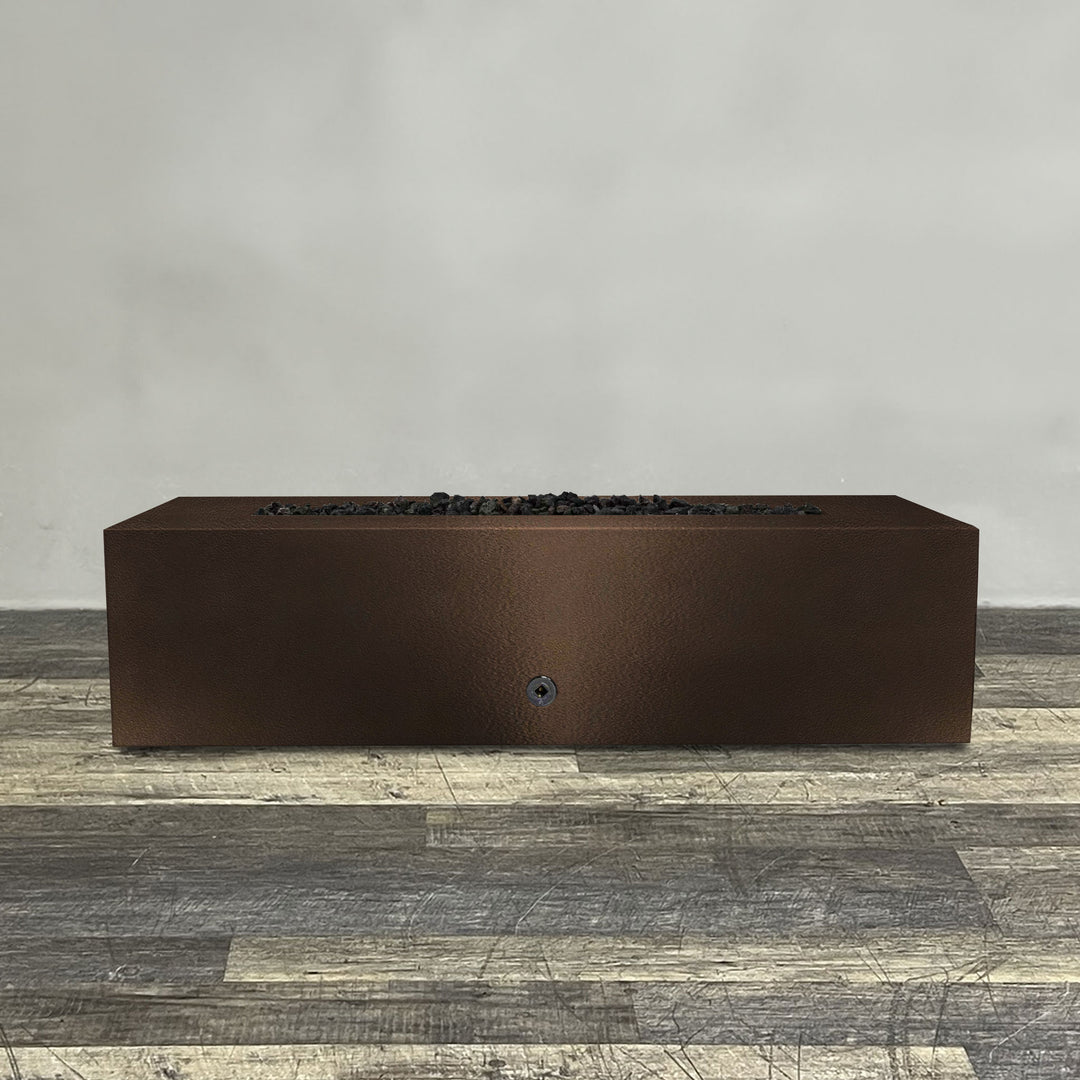 A side view of the 60" x 32" Rectangle Gravity Powder Coated Steel Fire Pit - Propane Gas Hardline - Push Button Spark Ignition - Bronze Hammertone by Starfire Designs - perfect for outdoor patio spaces. Natural gas or propane compatible, enhancing warmth and ambiance. Lava rocks included for added aesthetic.