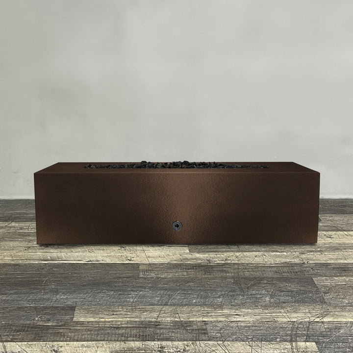 A side view of the 60" x 32" Rectangle Gravity Powder Coated Steel Fire Pit - Propane Gas Hardline - Push Button Spark Ignition - Bronze Hammertone by Starfire Designs - perfect for outdoor patio spaces. Natural gas or propane compatible, enhancing warmth and ambiance. Lava rocks included for added aesthetic.