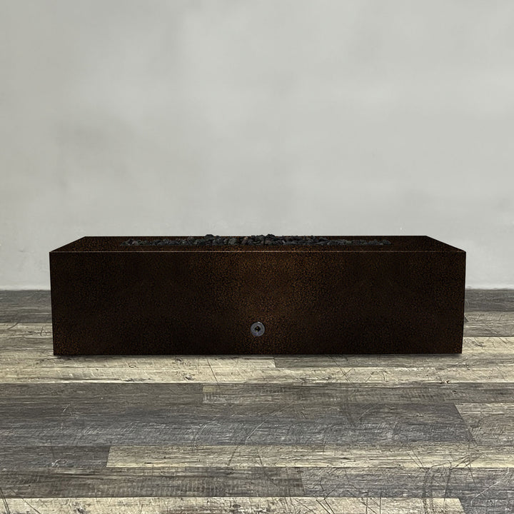 A side view of the 60" x 32" Rectangle Gravity Powder Coated Steel Fire Pit - Natural Gas - Push Button Spark Ignition - Copper Vein by Starfire Designs - perfect for outdoor patio spaces. Natural gas or propane compatible, enhancing warmth and ambiance. Lava rocks included for added aesthetic.