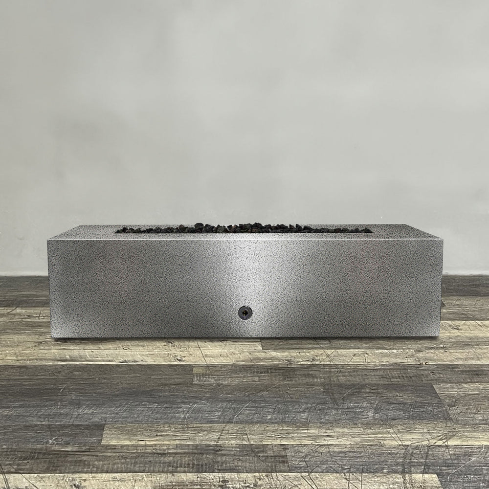 A side view of the 60" x 32" Rectangle Gravity Powder Coated Steel Fire Pit - Natural Gas - Flame Sense with Spark Ignition System - Silver Hammertone by Starfire Designs - perfect for outdoor patio spaces. Natural gas or propane compatible, enhancing warmth and ambiance. Lava rocks included for added aesthetic.