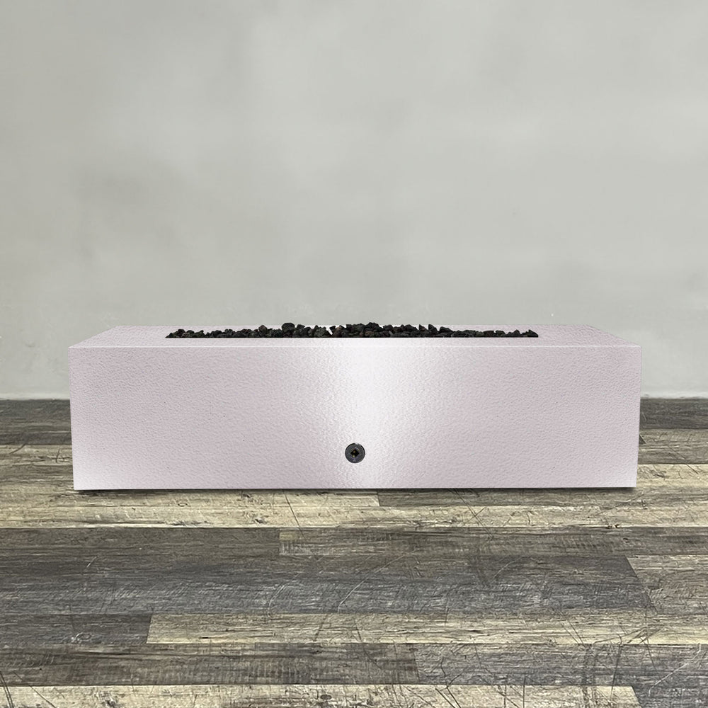 A side view of the 60" x 32" Rectangle Gravity Powder Coated Steel Fire Pit - Natural Gas - Flame Sense with Spark Ignition System - White Hammertone by Starfire Designs - perfect for outdoor patio spaces. Natural gas or propane compatible, enhancing warmth and ambiance. Lava rocks included for added aesthetic.