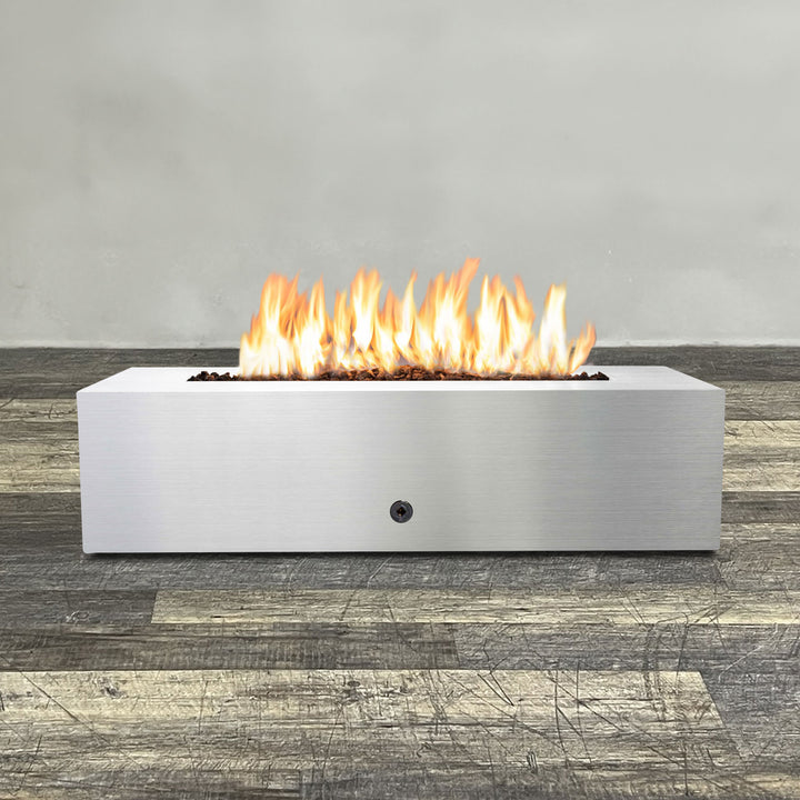 Front view of 60" x 24" Rectangle Gravity Stainless Steel Fire Pit by Starfire Designs - Brown with flames on, featuring sleek modern  design and durable construction, perfect for outdoor patio spaces. Natural gas or propane compatible, enhancing warmth and ambiance. Lava rocks included for added aesthetic.
