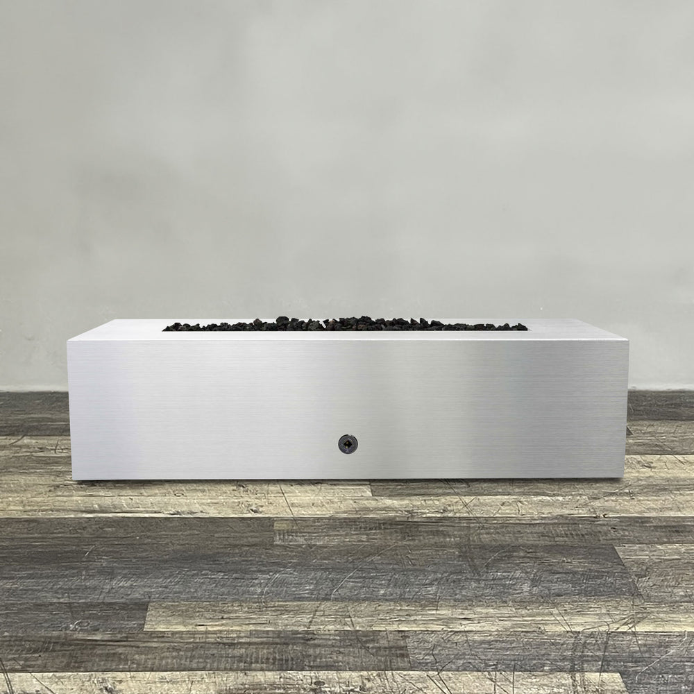 A side view of the 60" x 24" Rectangle Gravity Stainless Steel Fire Pit by Starfire Designs - perfect for outdoor patio spaces. Natural gas or propane compatible, enhancing warmth and ambiance. Lava rocks included for added aesthetic.
