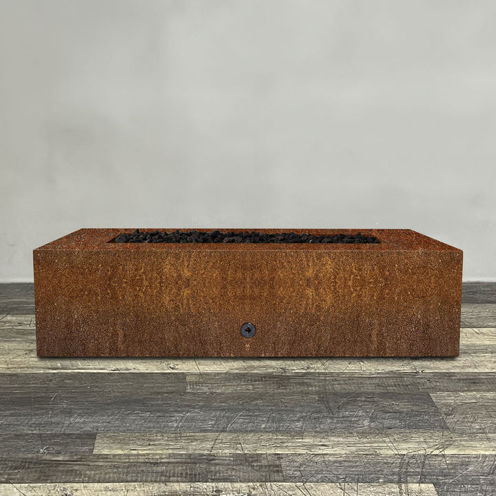 A side view of the 60" x 32" Rectangle Gravity Corten Steel Fire Pit by Starfire Designs - perfect for outdoor patio spaces. Natural gas or propane compatible, enhancing warmth and ambiance. Lava rocks included for added aesthetic.