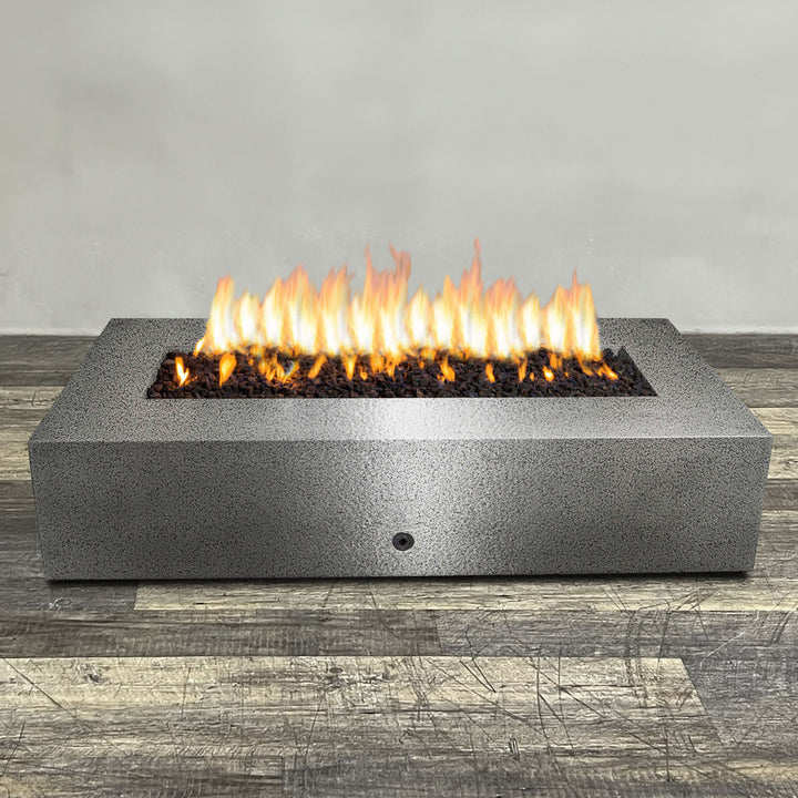 A side view of the 72" x 38" Rectangle Gravity Powder Coated Steel Fire Pit - Propane Gas Hardline - 110V CSA Hi/Lo Electronic Ignition System w/Bluetooth & Handheld Remote - Silver Hammertone by Starfire Designs - perfect for outdoor patio spaces. Natural gas or propane compatible, enhancing warmth and ambiance. Lava rocks included for added aesthetic.