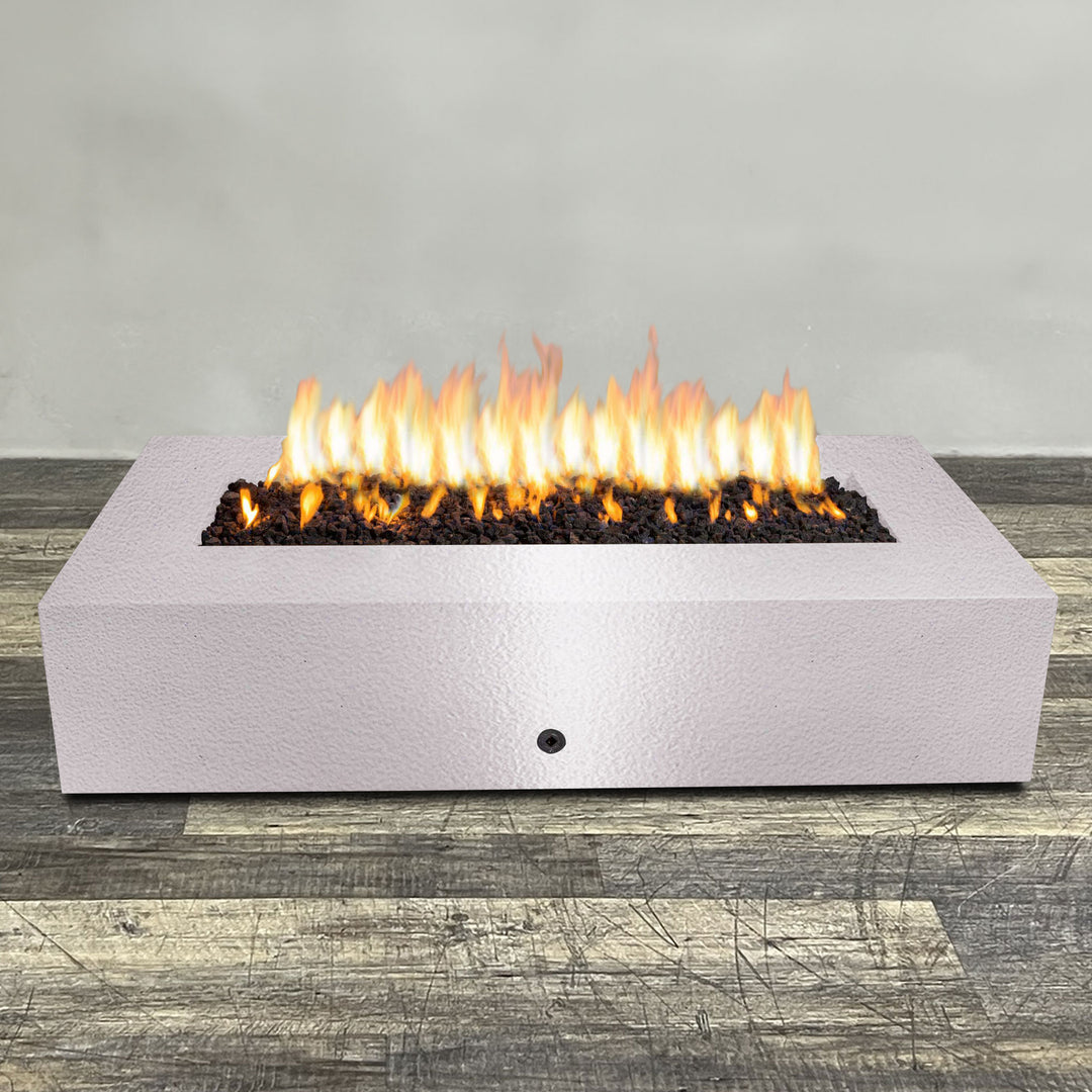 A side view of the 72" x 38" Rectangle Gravity Powder Coated Steel Fire Pit - Propane Gas Hardline - 110V CSA Hi/Lo Electronic Ignition System w/Bluetooth & Handheld Remote - White Hammertone by Starfire Designs - perfect for outdoor patio spaces. Natural gas or propane compatible, enhancing warmth and ambiance. Lava rocks included for added aesthetic.