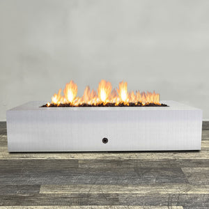 Front view of 72" x 38" Rectangle Gravity Stainless Steel Fire Pit - Natural Gas - Match Lit by Starfire Designs - Brown with flames on, featuring sleek modern  design and durable construction, perfect for outdoor patio spaces. Natural gas or propane compatible, enhancing warmth and ambiance. Lava rocks included for added aesthetic.