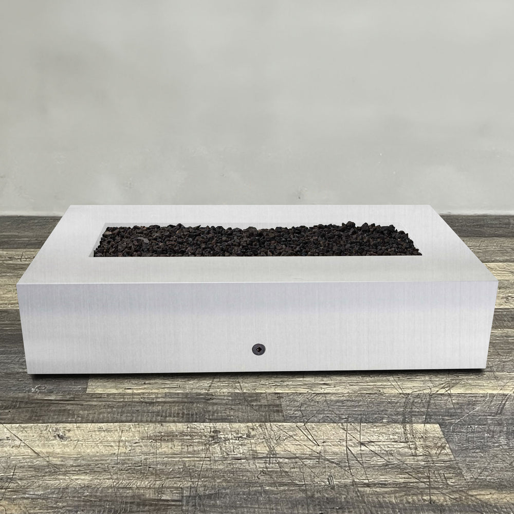 Front view of 72" x 38" Rectangle Gravity Stainless Steel Fire Pit by Starfire Designs - Brown with flames on, featuring sleek modern  design and durable construction, perfect for outdoor patio spaces. Natural gas or propane compatible, enhancing warmth and ambiance. Lava rocks included for added aesthetic.