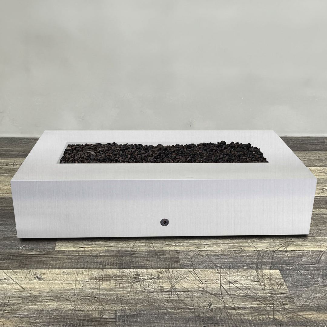 Front view of 72" x 38" Rectangle Gravity Stainless Steel Fire Pit by Starfire Designs - Brown with flames on, featuring sleek modern  design and durable construction, perfect for outdoor patio spaces. Natural gas or propane compatible, enhancing warmth and ambiance. Lava rocks included for added aesthetic.