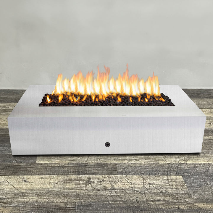 A side view of the 72" x 38" Rectangle Gravity Stainless Steel Fire Pit by Starfire Designs - perfect for outdoor patio spaces. Natural gas or propane compatible, enhancing warmth and ambiance. Lava rocks included for added aesthetic.
