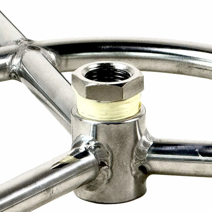 Close-up image of the Athena Fire Glass Fire Ring center hub and reducer, showing the solid stainless steel threading and precision-machined fittings that ensure a secure gas-tight seal.