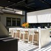 Close-up of a luxurious outdoor bar setup with white marble countertops and Bromic Tungsten Electric Smart-Heat heater overhead, providing radiant warmth under a sleek black pergola.
