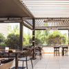 Modern café patio with Bromic Heating Tungsten Electric Smart-Heat heaters mounted beneath a slatted pergola roof, providing comfortable radiant warmth for outdoor dining guests.