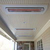Covered porch with multiple Bromic Tungsten Smart-Heat heaters mounted in white recessed kits, blending seamlessly into the ceiling to provide discreet radiant warmth.