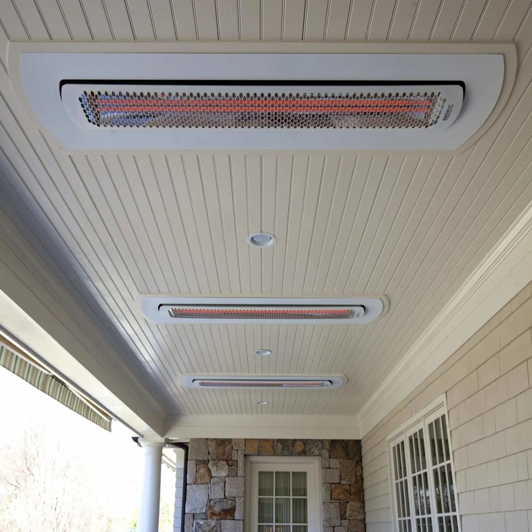 Covered porch with multiple Bromic Tungsten Smart-Heat heaters mounted in white recessed kits, blending seamlessly into the ceiling to provide discreet radiant warmth.