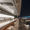 Rooftop bar at the InterContinental Los Angeles Downtown with Bromic Tungsten Smart-Heat recessed heaters installed along the ceiling, providing stylish warmth for nighttime guests.