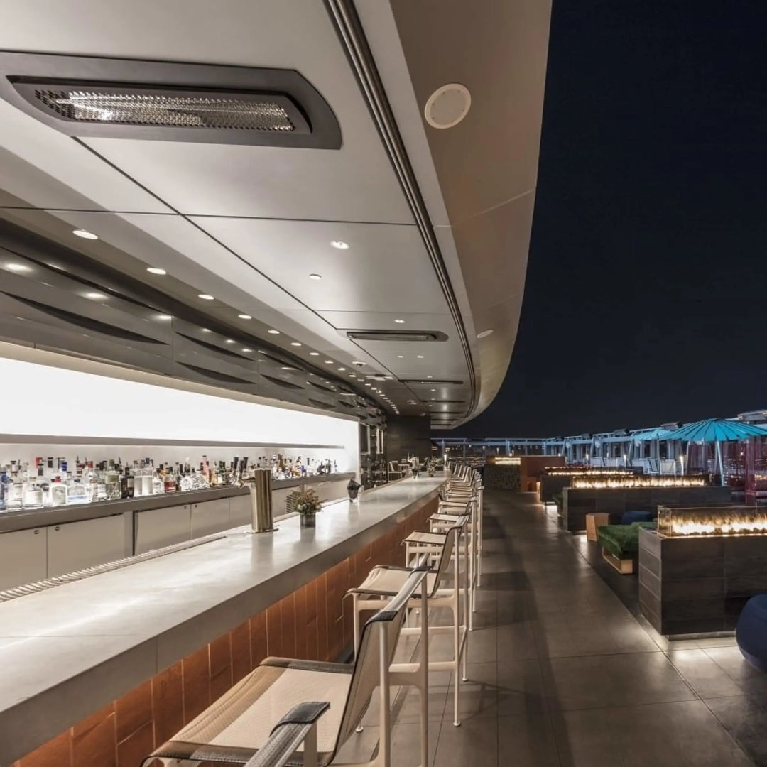 Rooftop bar at the InterContinental Los Angeles Downtown with Bromic Tungsten Smart-Heat recessed heaters installed along the ceiling, providing stylish warmth for nighttime guests.