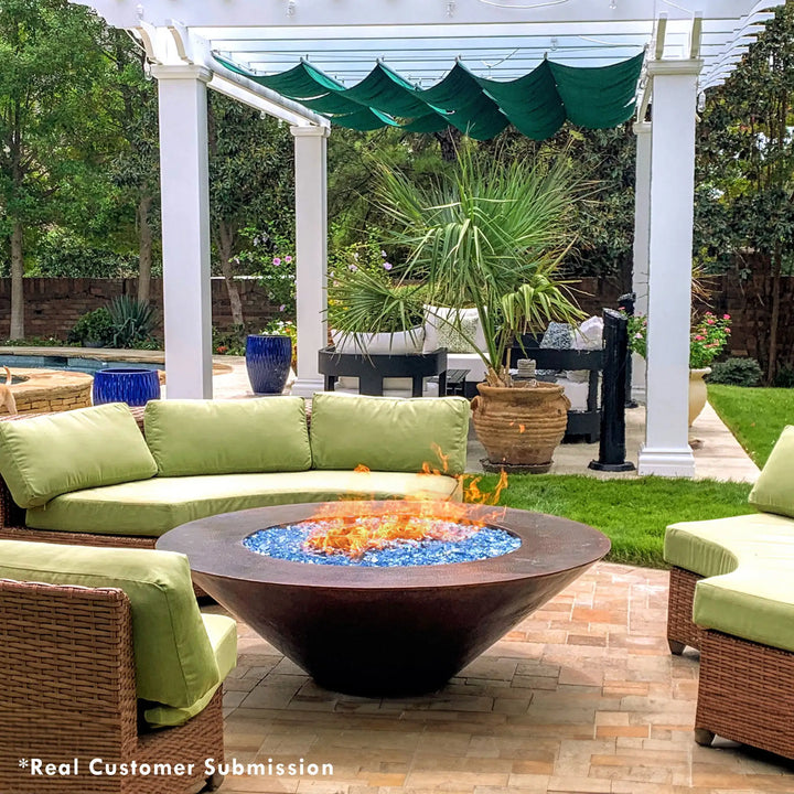 Cono Moreno 48-inch Round Copper Fire Pit in a lush outdoor setting, with cozy seating, displaying real customer use