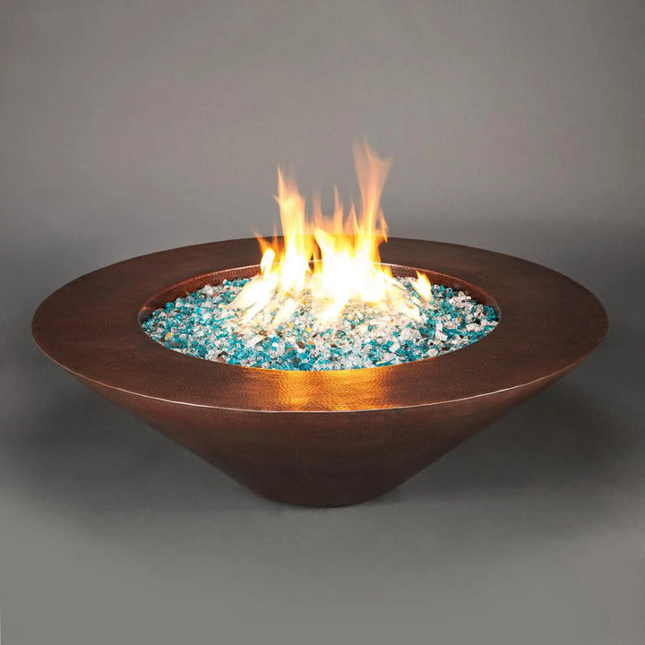 Cono Moreno 48-inch Round Copper Fire Pit with dancing flames, showcasing its elegant copper design and vibrant blue fire glass