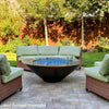 Cono Moreno 48-inch Round Copper Fire Pit with a glass wind guard, enhancing safety while preserving the stunning copper finish