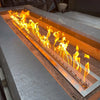 Close-up view of the HPC Fire Inspired Linear Torpedo T-Burner producing bold flames in a stainless steel trough,  demonstrating high-performance heat and clean modern design for outdoor fire features.