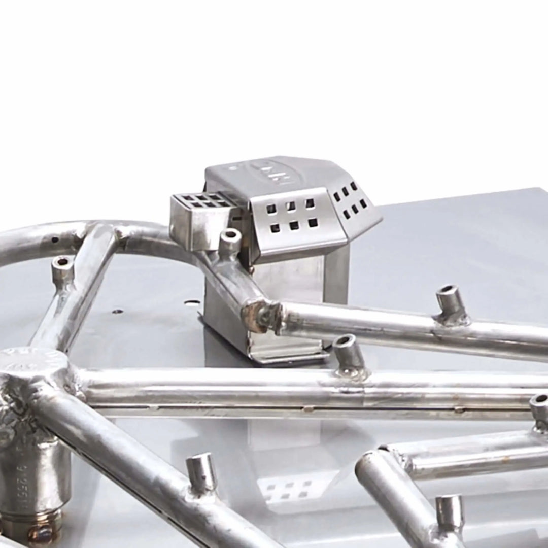 Close-up view of the flame-sensing blowout box assembly on the HPC Fire certified Torpedo Penta burner / highlighting the wind-resistant housing and integrated ignition safety components.