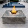 Poolside fire pit with a Square Drop-In Penta Burner installed in a luxurious granite-topped enclosure, producing elegant flames for elevated outdoor entertaining.