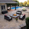 Luxury backyard patio featuring a square fire pit with bright flames, surrounded by wicker seating and overlooking a poolside oasis for entertaining.