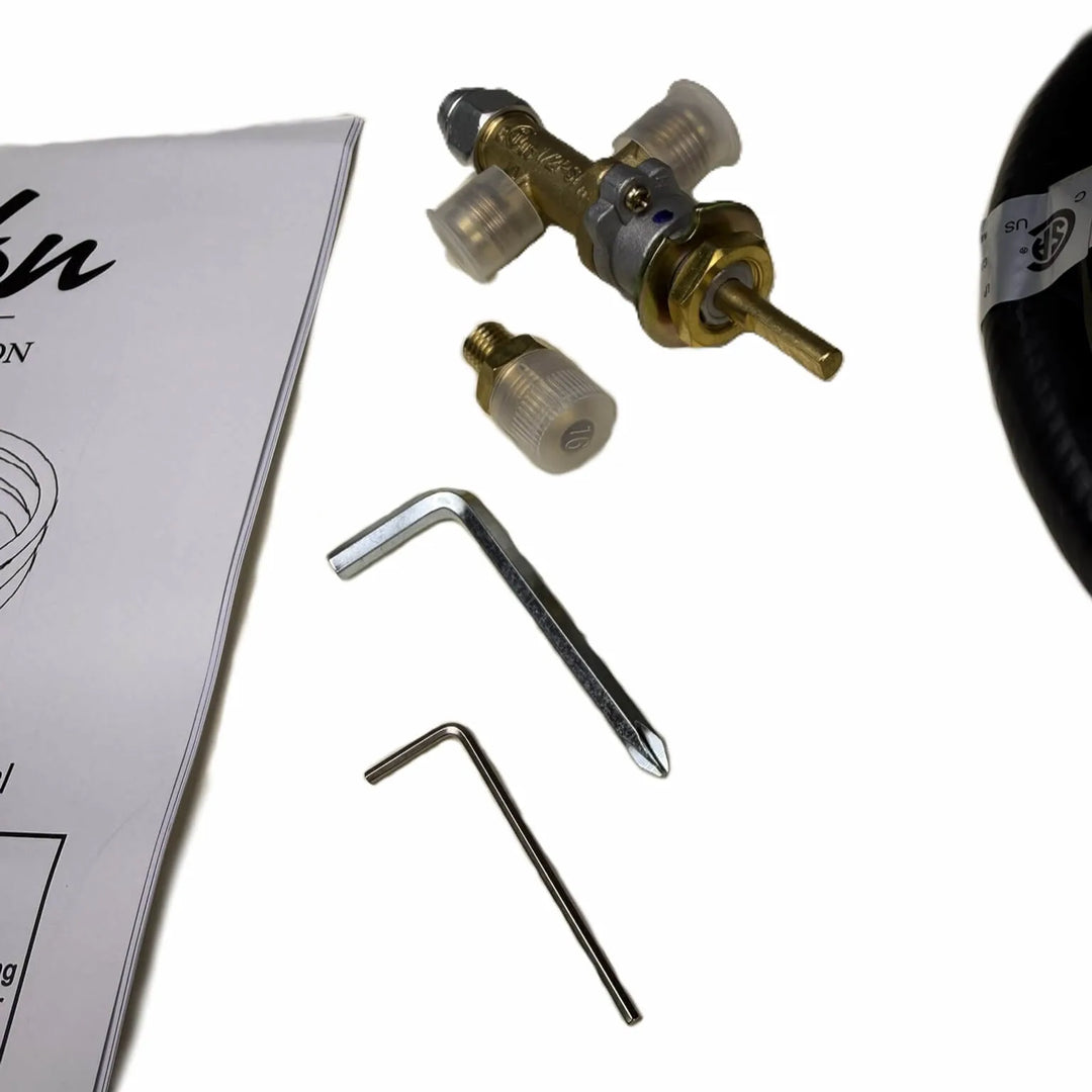 Close-up of Béton Fire Pit Natural Gas to Propane Conversion Kit components including brass valve, orifice fittings, and installation tools.