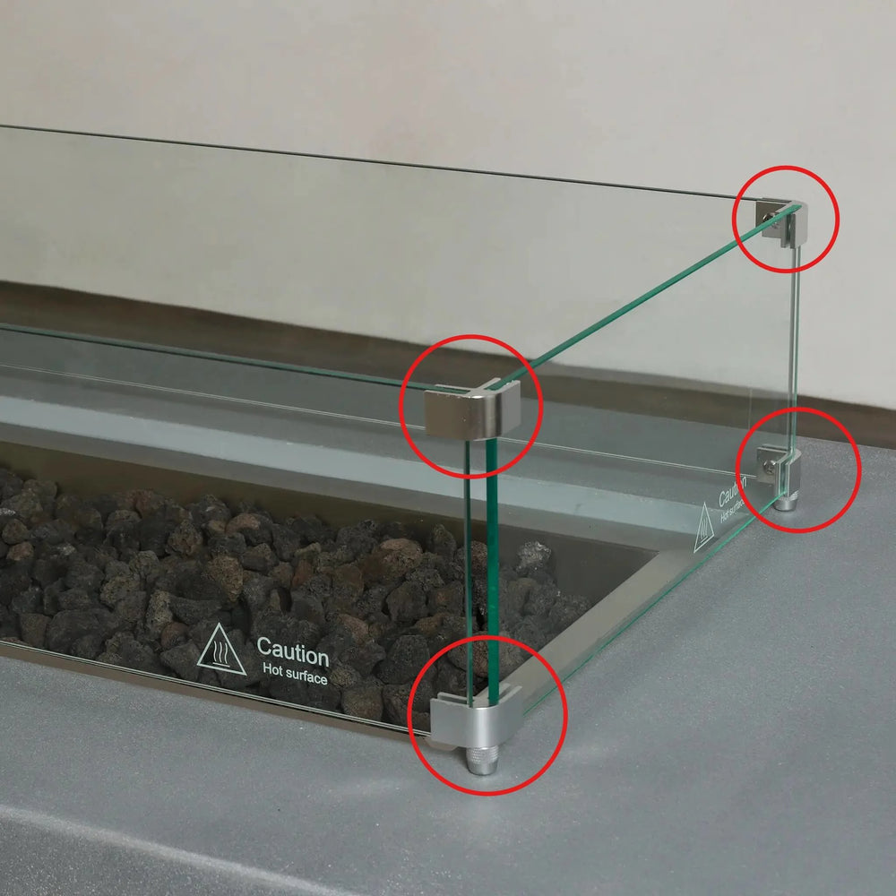 Installed Starfire Designs Béton Fire Pit Rectangle Linear Glass Wind Guard Clips securing clear glass panels around the burner, helping block wind and maintain steady flames for outdoor enjoyment.