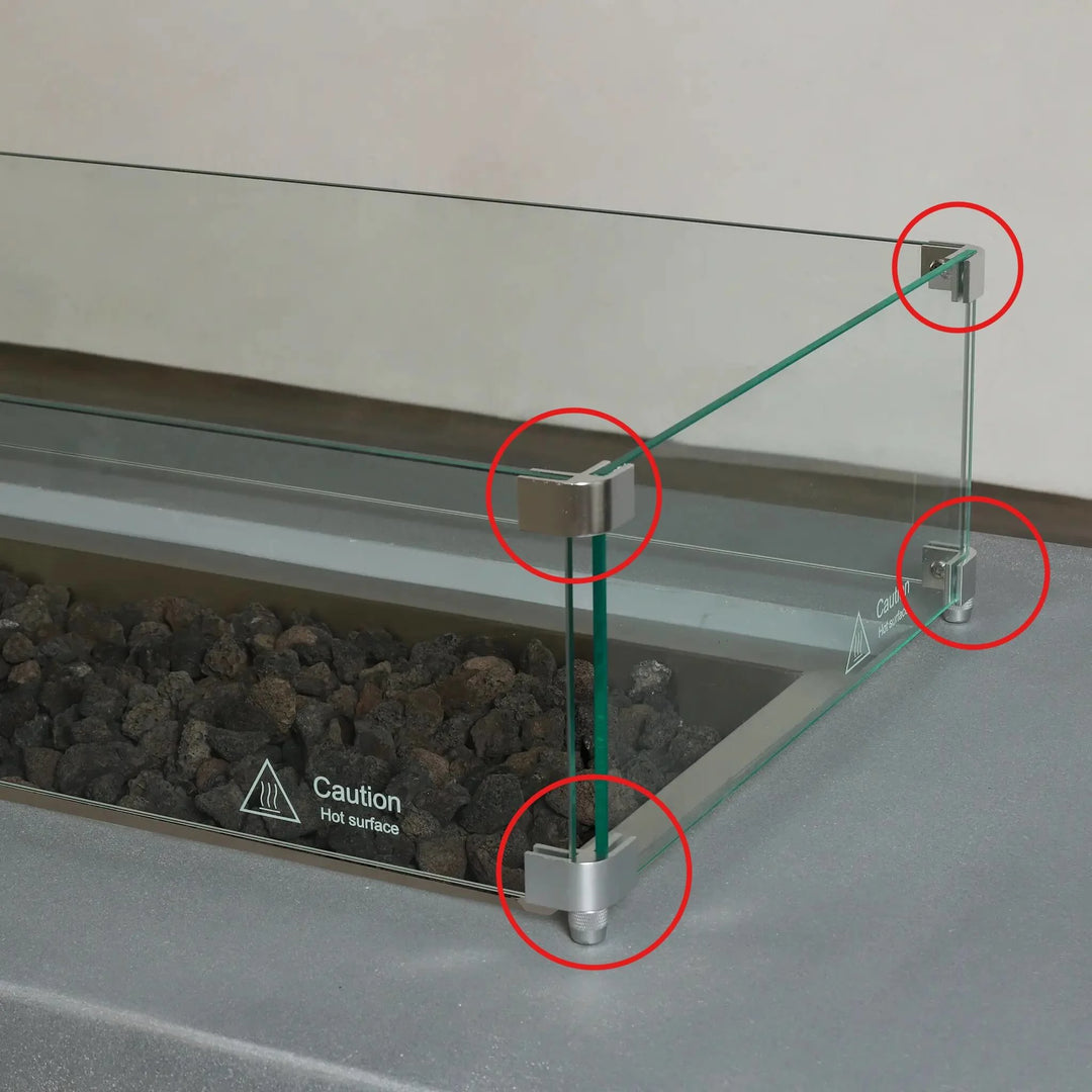 Installed Starfire Designs Béton Fire Pit Rectangle Linear Glass Wind Guard Clips securing clear glass panels around the burner, helping block wind and maintain steady flames for outdoor enjoyment.