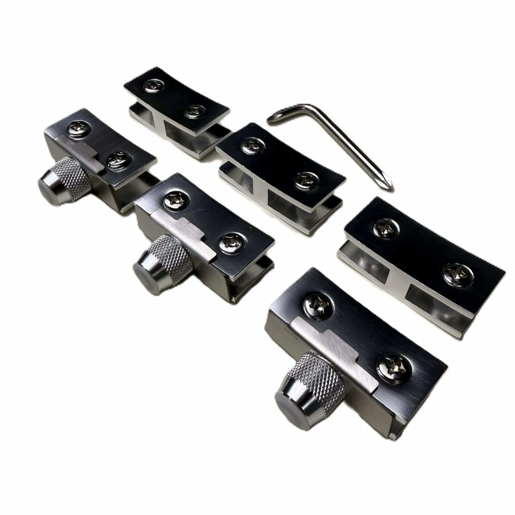 Close-up of the Starfire Designs Béton Fire Pit Replacement Round Glass Wind Guard Clips Kit showing four stainless steel clips with adjustment knobs and an included hex key tool.