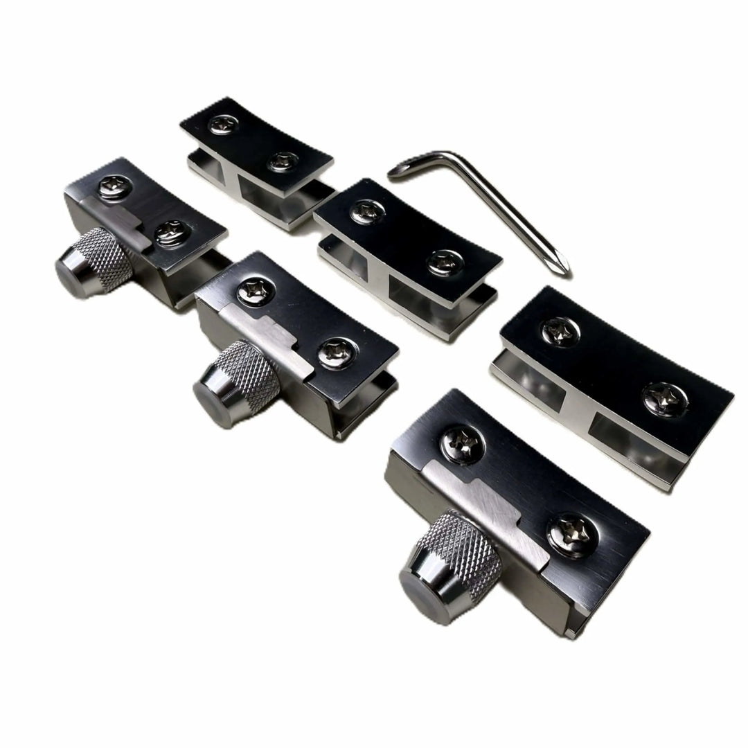 Close-up of the Starfire Designs Béton Fire Pit Replacement Round Glass Wind Guard Clips Kit showing four stainless steel clips with adjustment knobs and an included hex key tool.