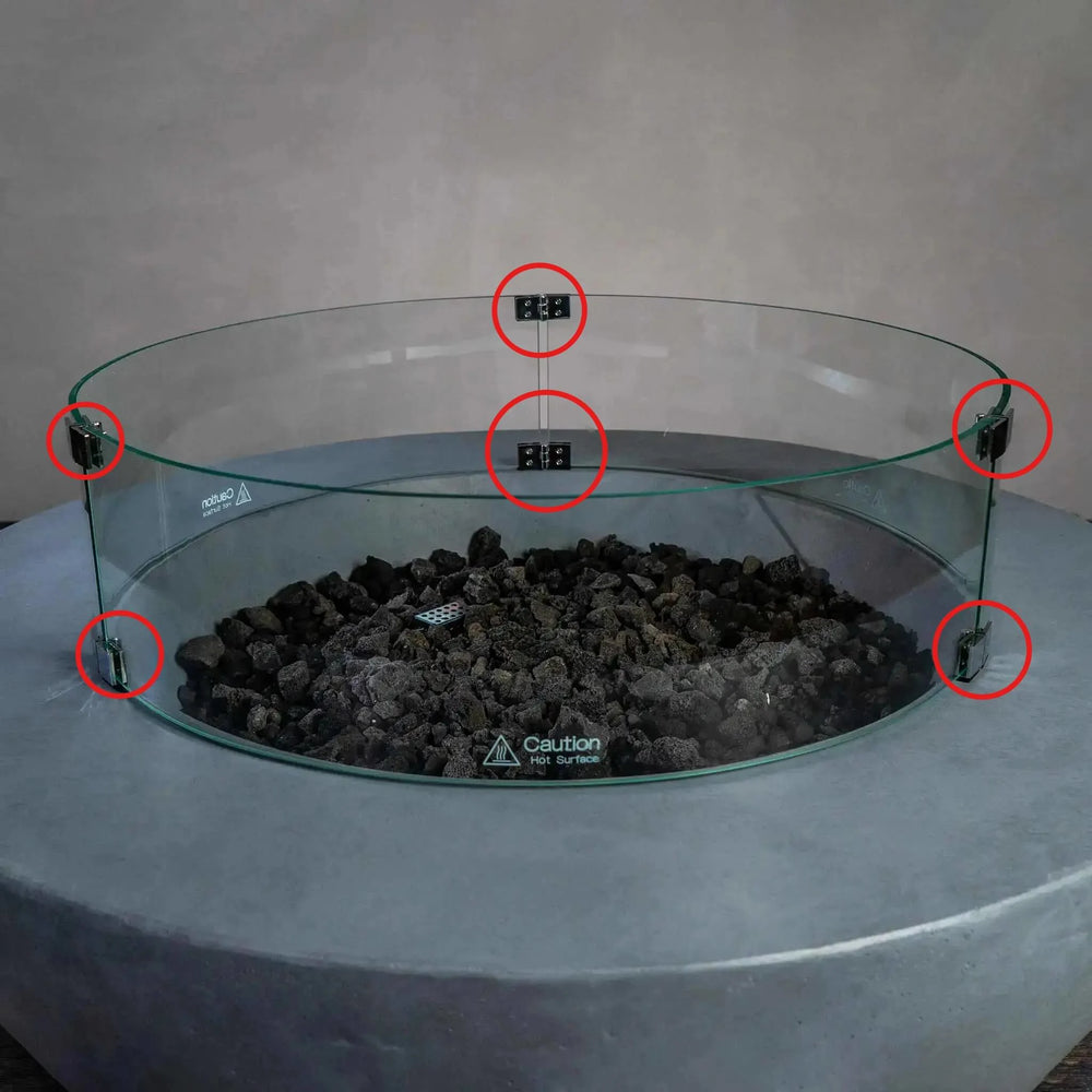 Installed Starfire Designs Béton Fire Pit Round Glass Wind Guard Clips securely holding a circular glass barrier around the fire pit, keeping flames protected from wind while maintaining a sleek, modern look.