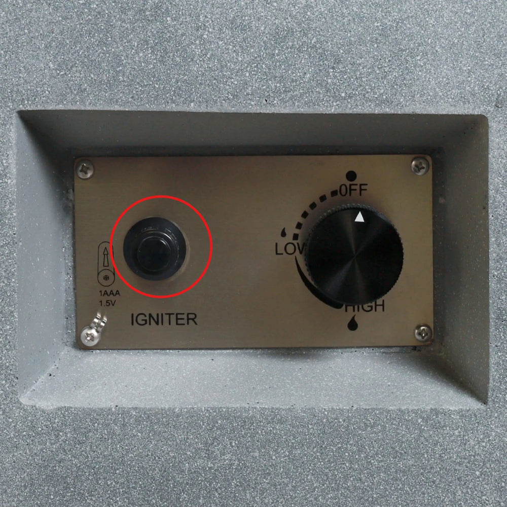 Installed Starfire Designs Béton Fire Pit Spark Button on the control panel, circled to highlight its placement next to the flame control knob for convenient ignition.