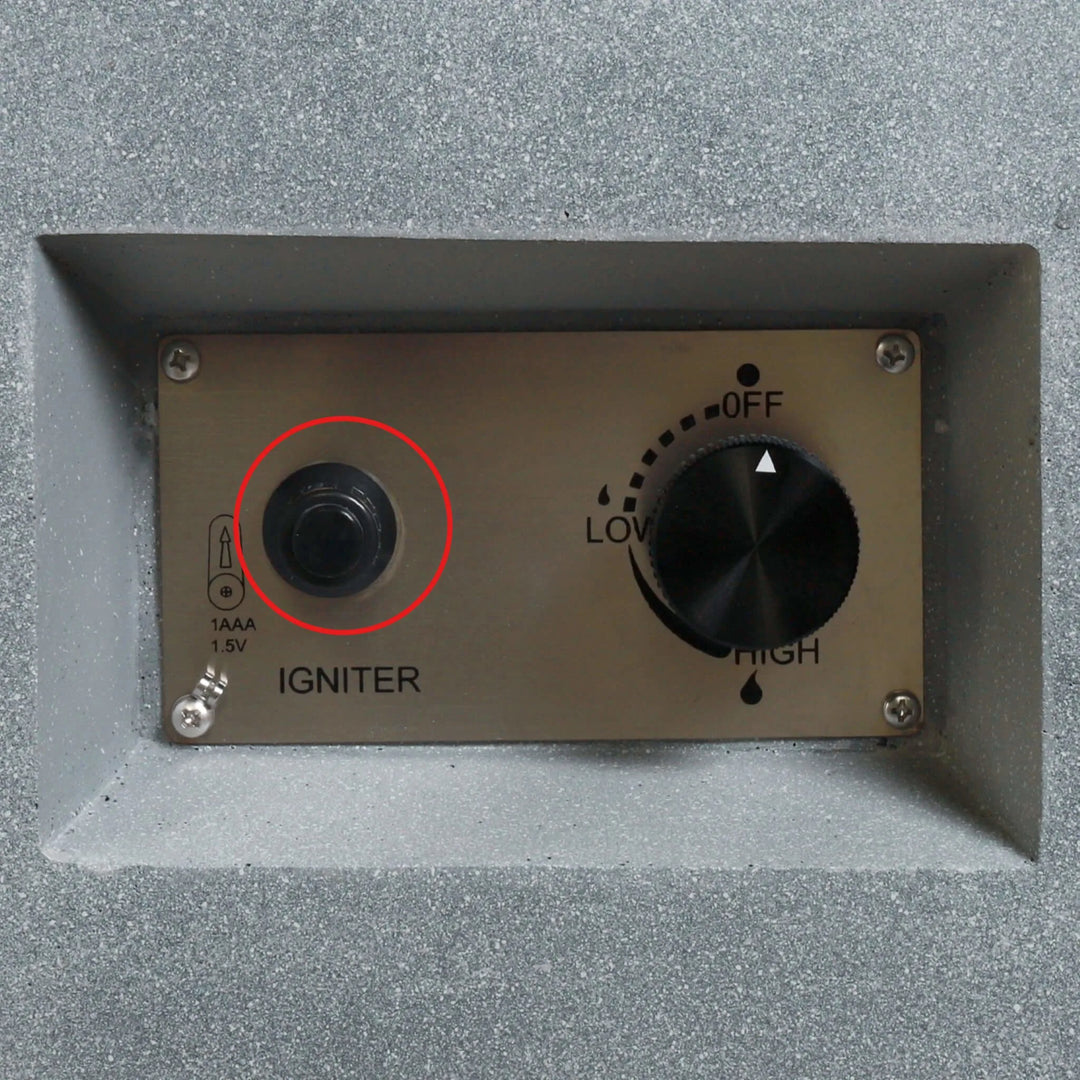 Installed Starfire Designs Béton Fire Pit Spark Button on the control panel, circled to highlight its placement next to the flame control knob for convenient ignition.